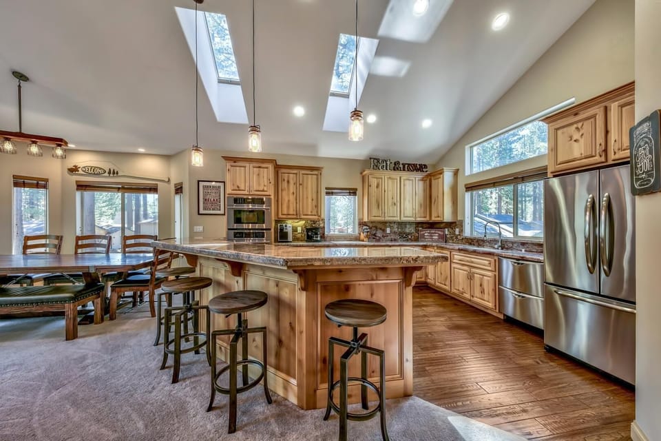 This gourmet kitchen with stainless steel appliances and granite countertops has plenty of space for any helping hands