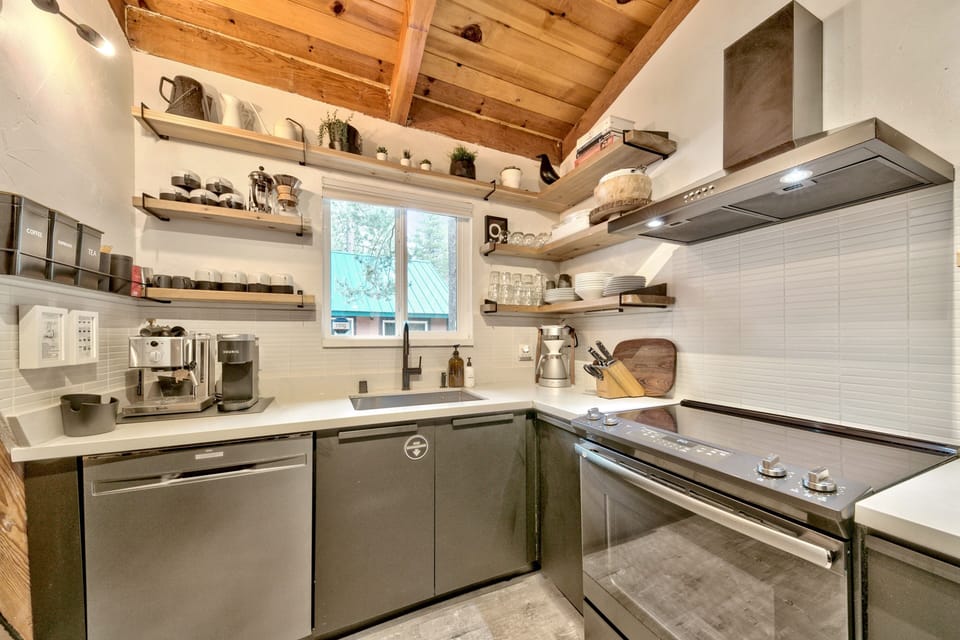 Your fully-equipped kitchen features rustic exposed beams, modern appliances, and open shelving stocked with everything you need to create memorable meals during your stay.