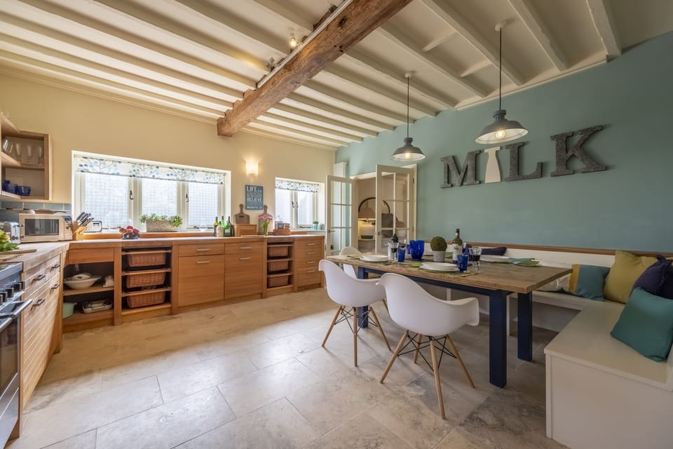 Ground floor: Spacious kitchen with a dining table, chairs and banquette seating