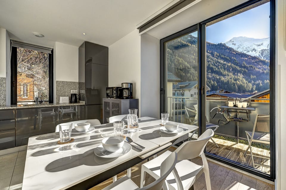 Dining table in front of glass doors with view towards Mont Blanc