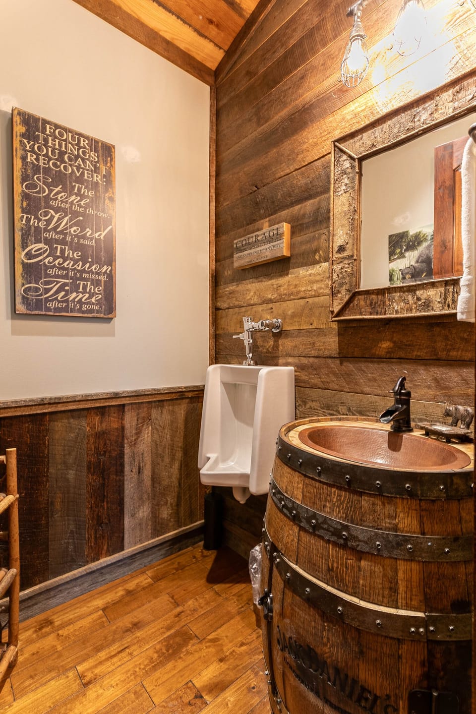 Rustic charm at its finest. A whiskey barrel vanity and reclaimed wood walls give this bath serious mountain personality.
