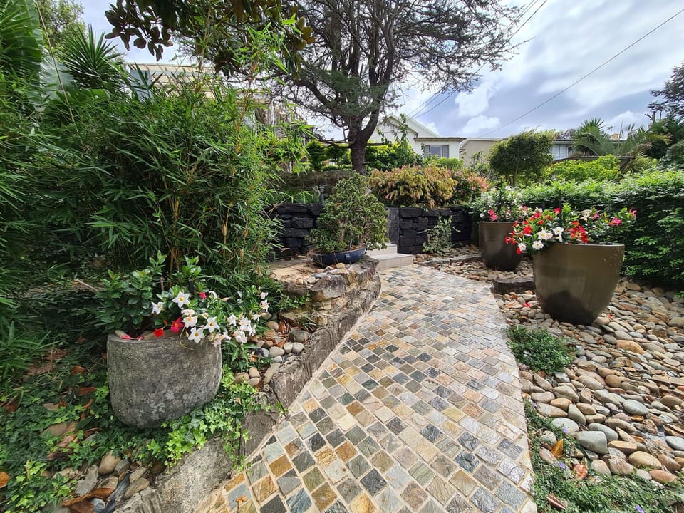 Front of the house with magnificent garden and pathway  