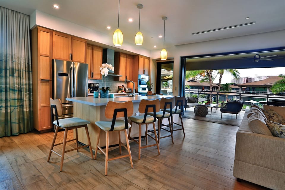 Beautiful granite kitchen island with bar seating & tropical outdoor views