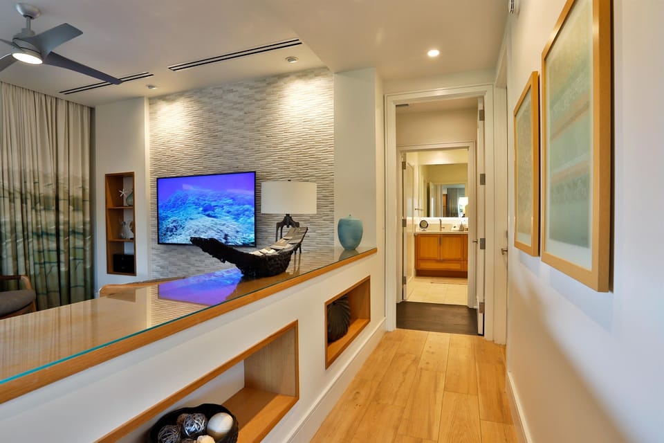 Make your way through the open hallway to the first primary bed & bath