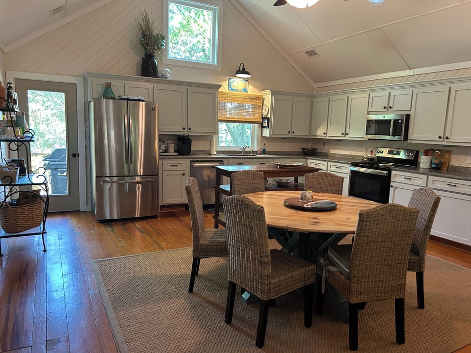 Dining table & island for serving or prepping. Back deck with grill off kitchen.