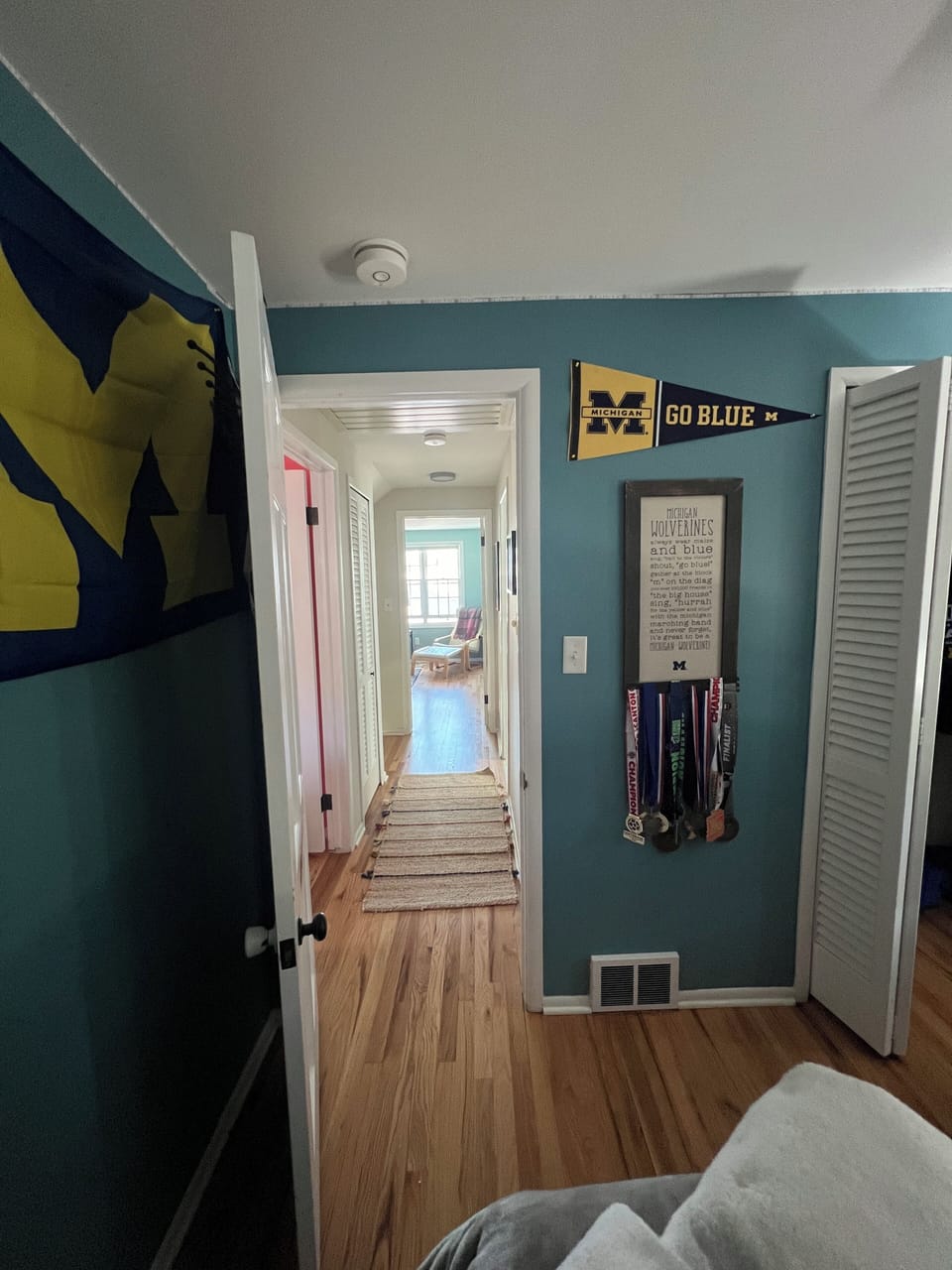 Second floor bedroom facing hallway and primary bedroom in background