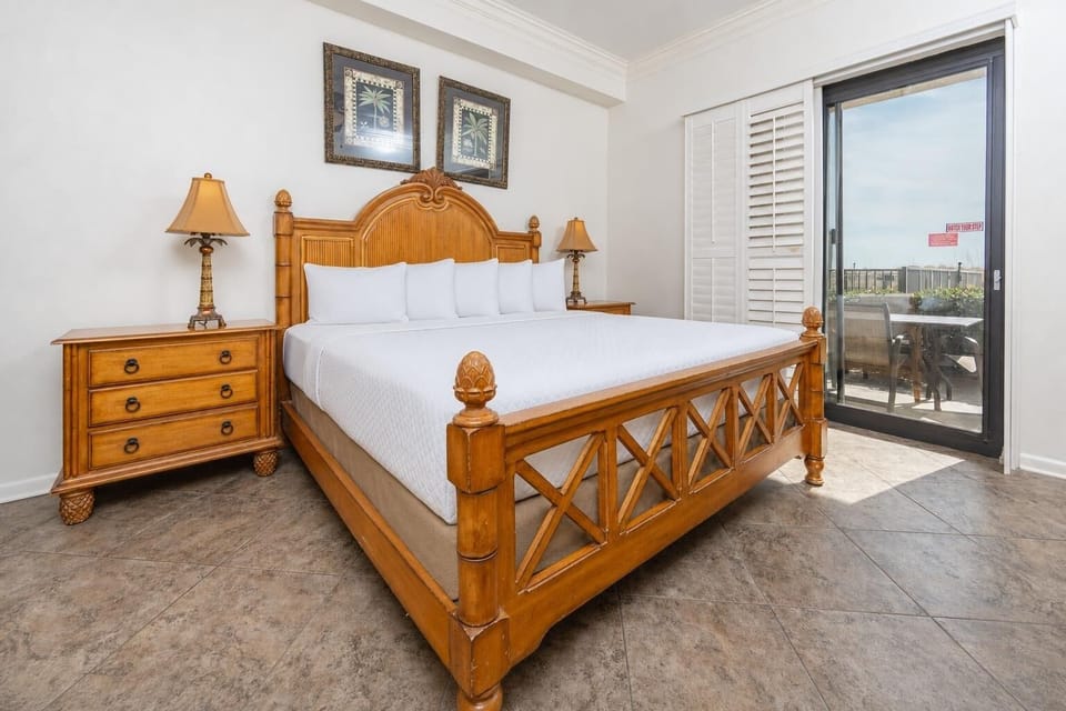 In the king master suite, you sink into crisp linens and enjoy peaceful moments beside patio doors