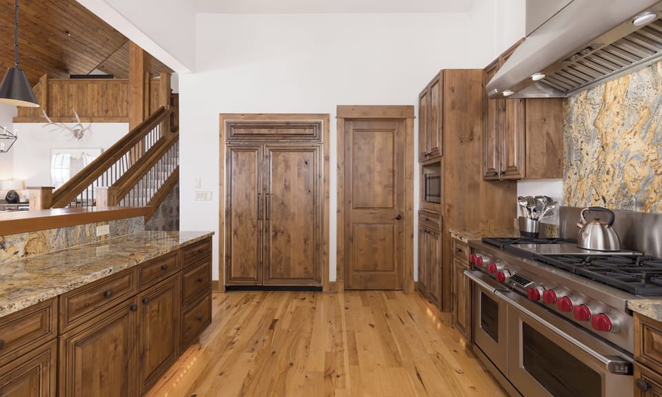 Your gourmet kitchen awaits with rich wooden cabinetry, granite counters, and professional-grade appliances for memorable meals.