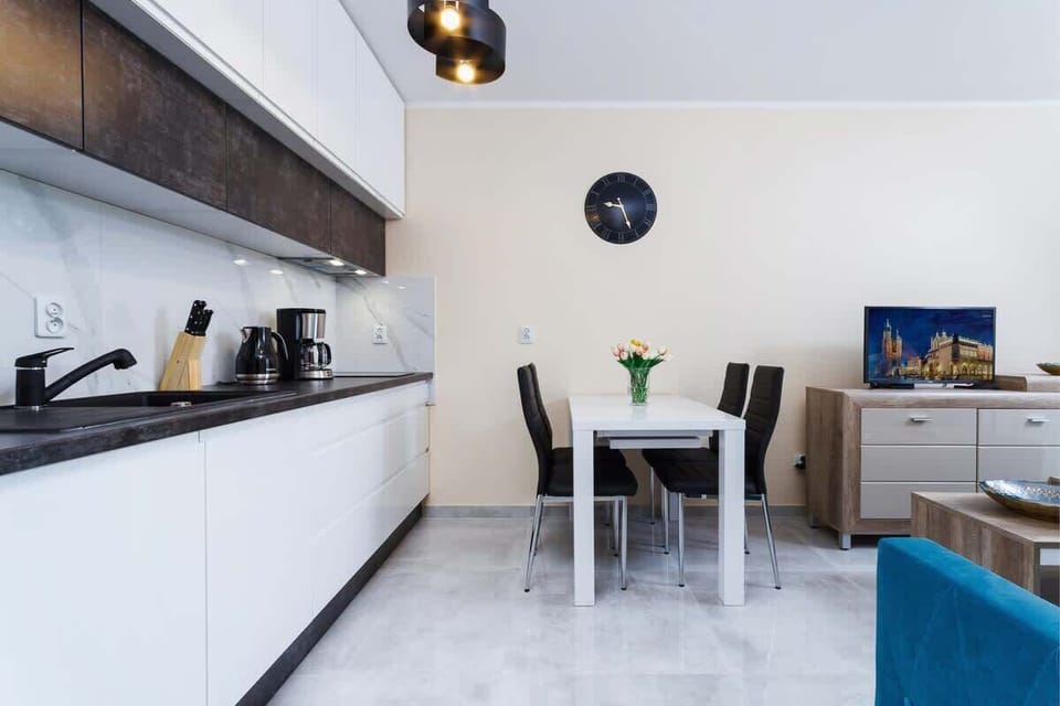 A modern kitchen countertop with utensils and small appliances neatly arranged.
