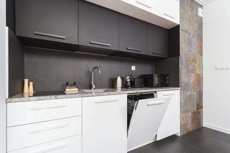 Modern kitchenette with high-quality appliances such as a dishwasher, among others. 