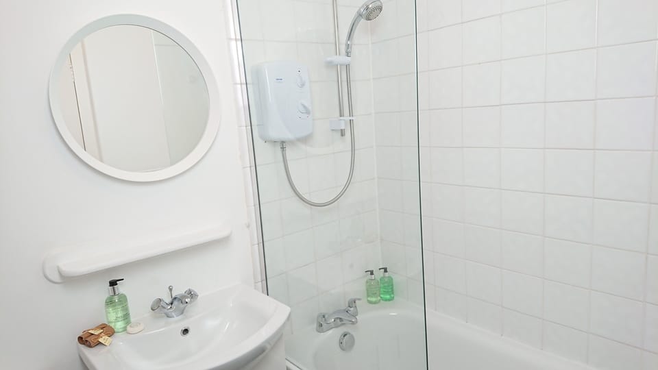 Shower over bath with complimentary toiletries.