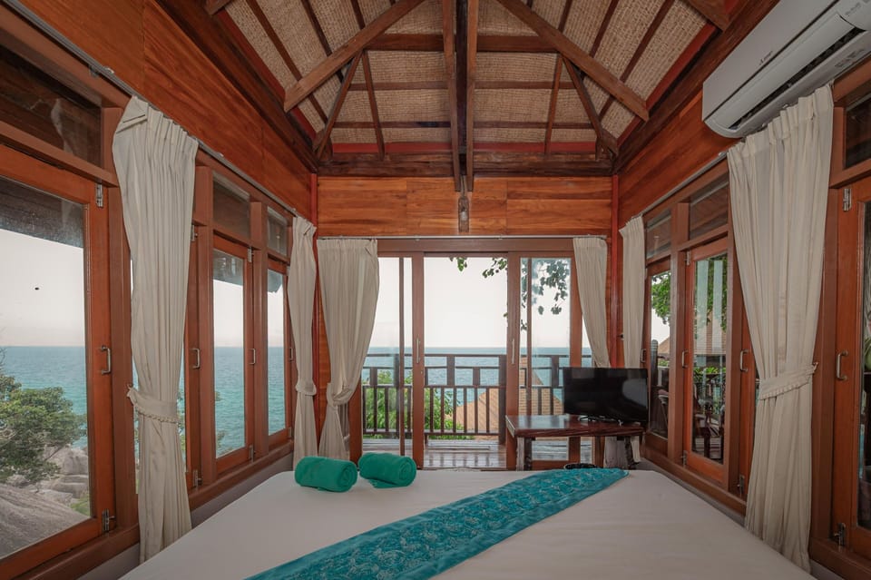 Prime Seafront Family Suite Villa | Minibar, desk, laptop workspace, blackout drapes