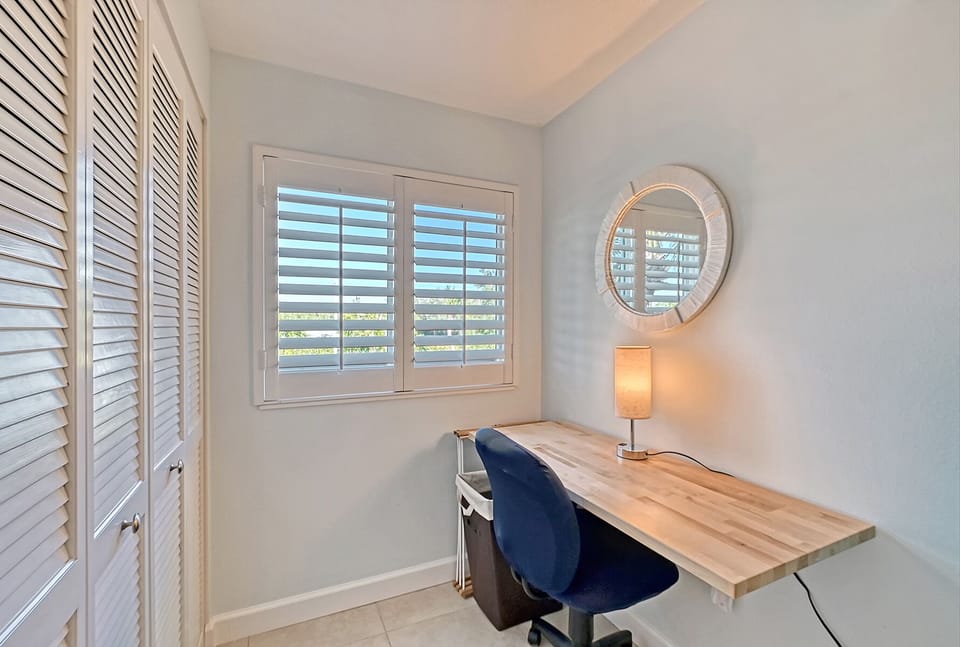 Desk area. Washer dryer behind doors