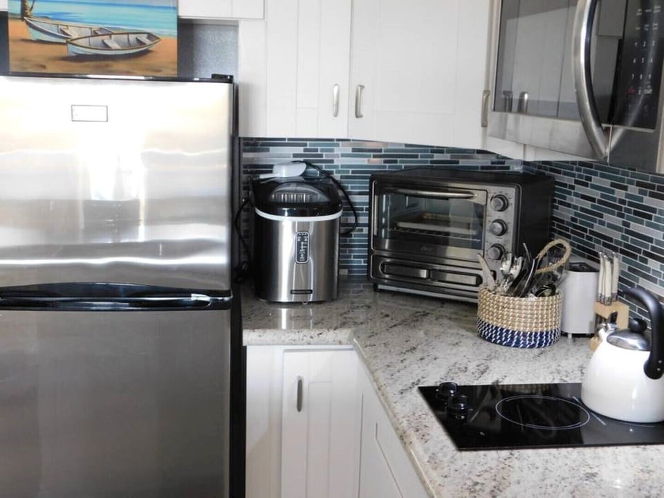 This kitchen has everything you need .  There’s even a counter ice maker machine