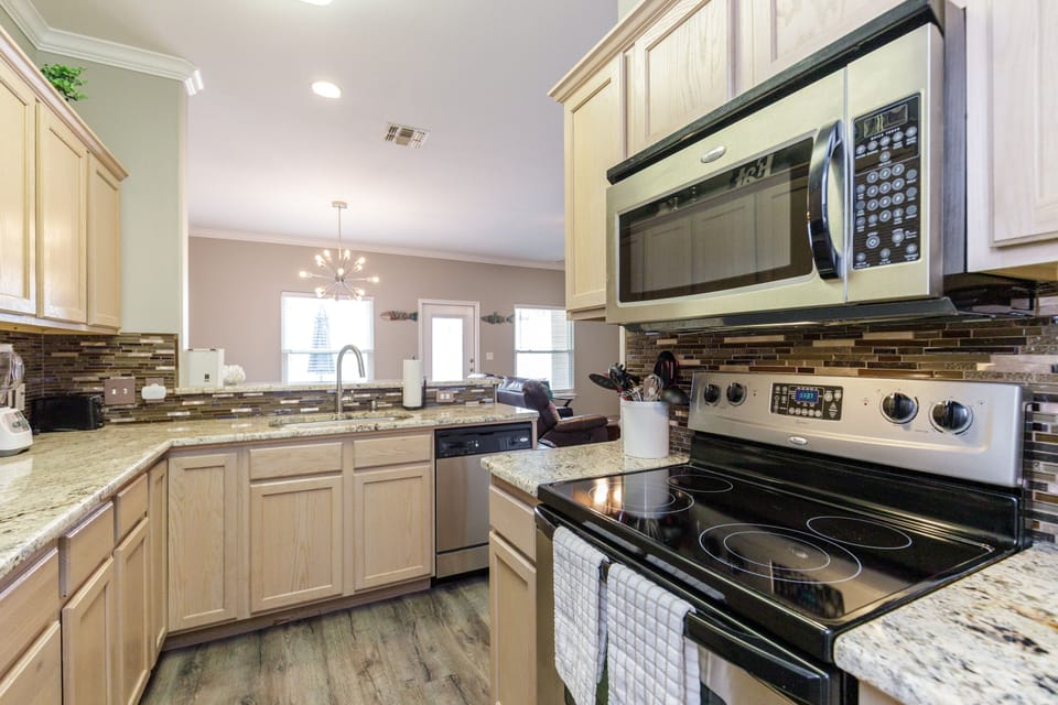 Your fully-equipped kitchen awaits with granite counters, stainless appliances, and everything needed to create memorable meals during your stay.