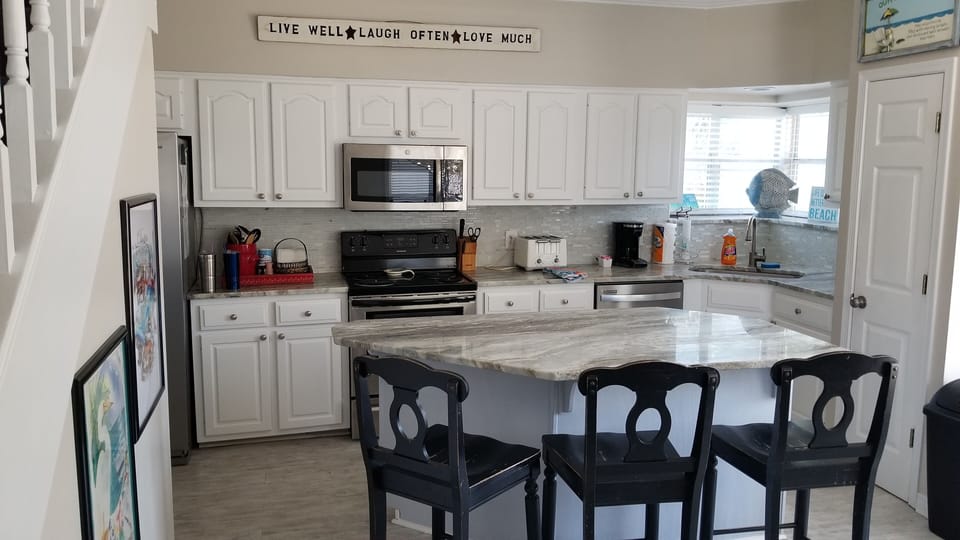 Kitchen with granite counters and huge center island with breakfast bar.