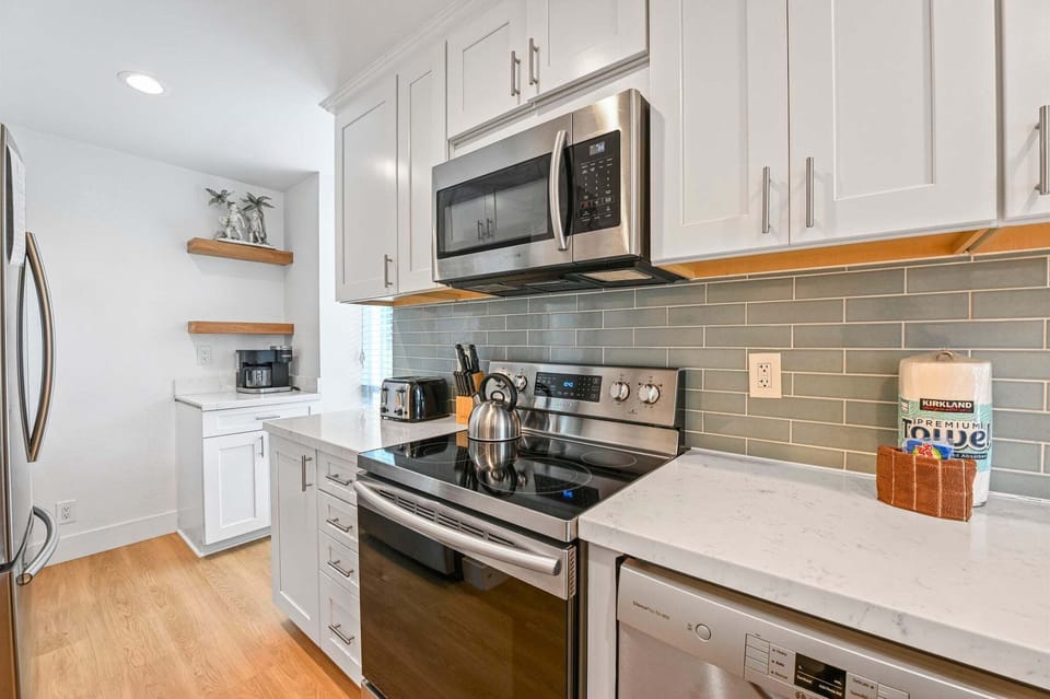 The kitchen features elegant white quartz countertops and a stylish tile backsplash.