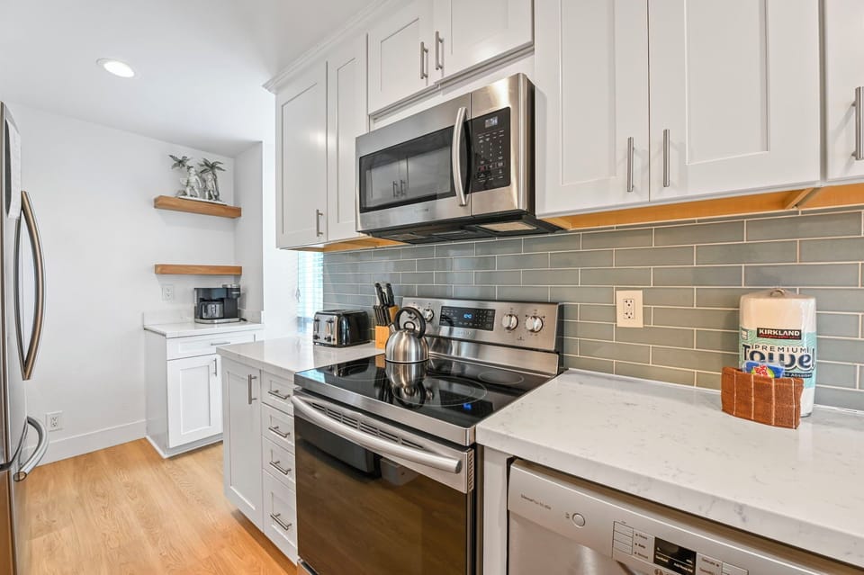 The kitchen features elegant white quartz countertops and a stylish tile backsplash.