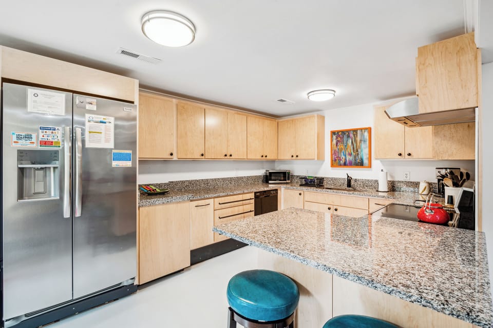 Spacious updated kitchen with new appliances and plenty of granite countertop space makes it easy to prep meals.