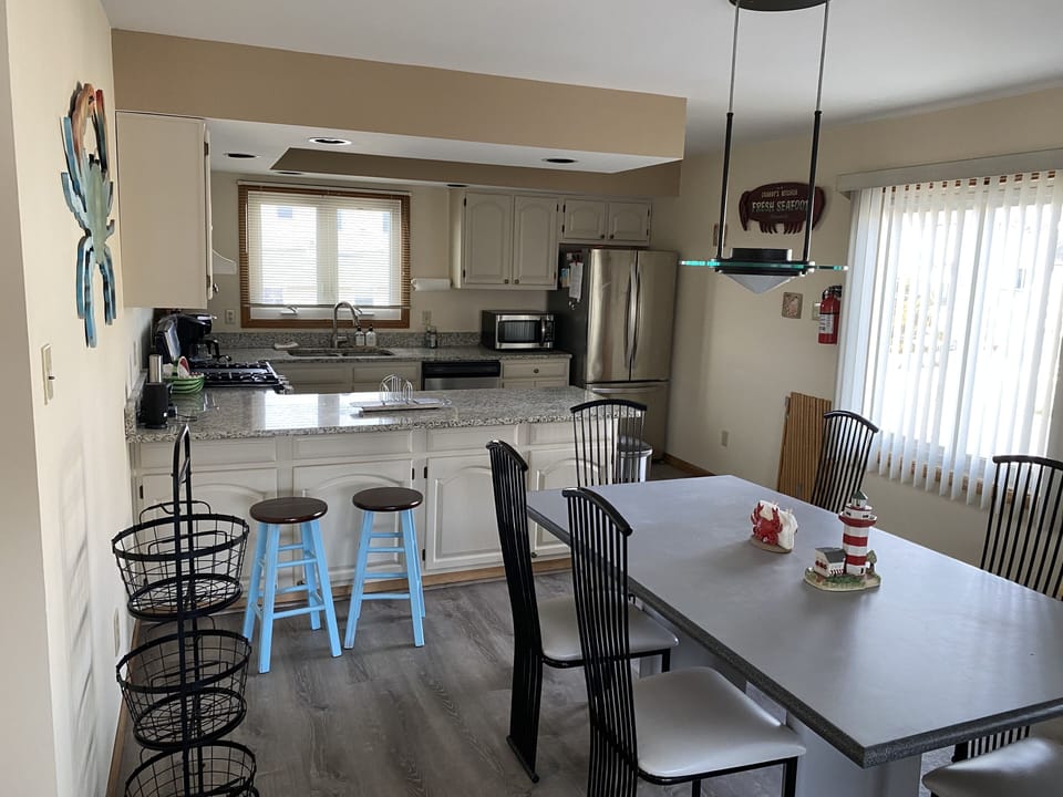 View of dining area and kitchen . Oversized table with 6 chairs 