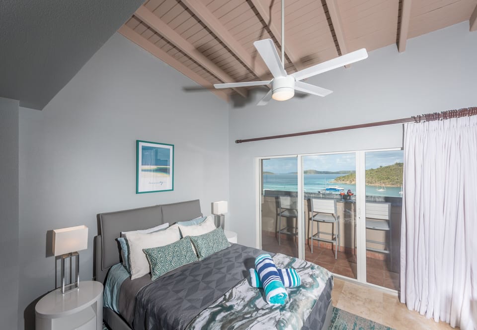 Bedroom leads to patio with granite bar overlooking Cruz Bay and outer islands.