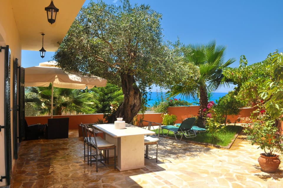 large sun terrace with garden furniture and sea view.