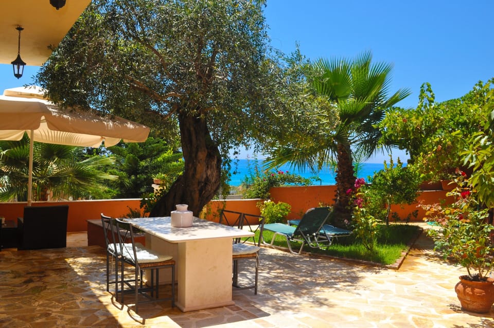 large terrace filled with flowers, trees and plants.