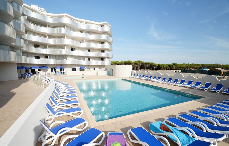 Lounge by the pool in the sunshine.