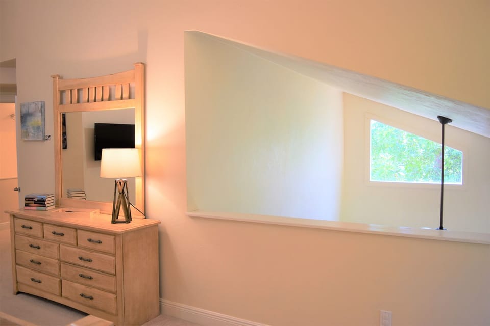 The whimsical opening lets in even more light from the great room below.