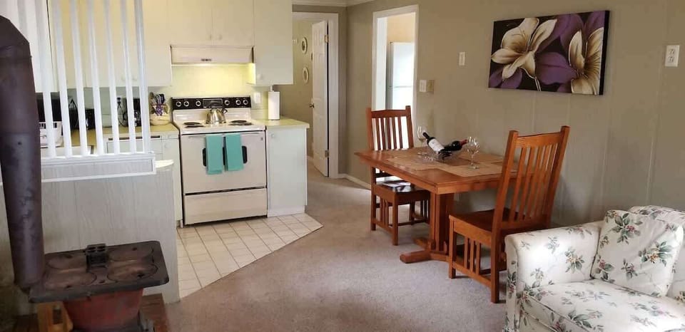 View of Dining & Kitchen + Bed Room Doorway & Fridge to Bathroom Doorway