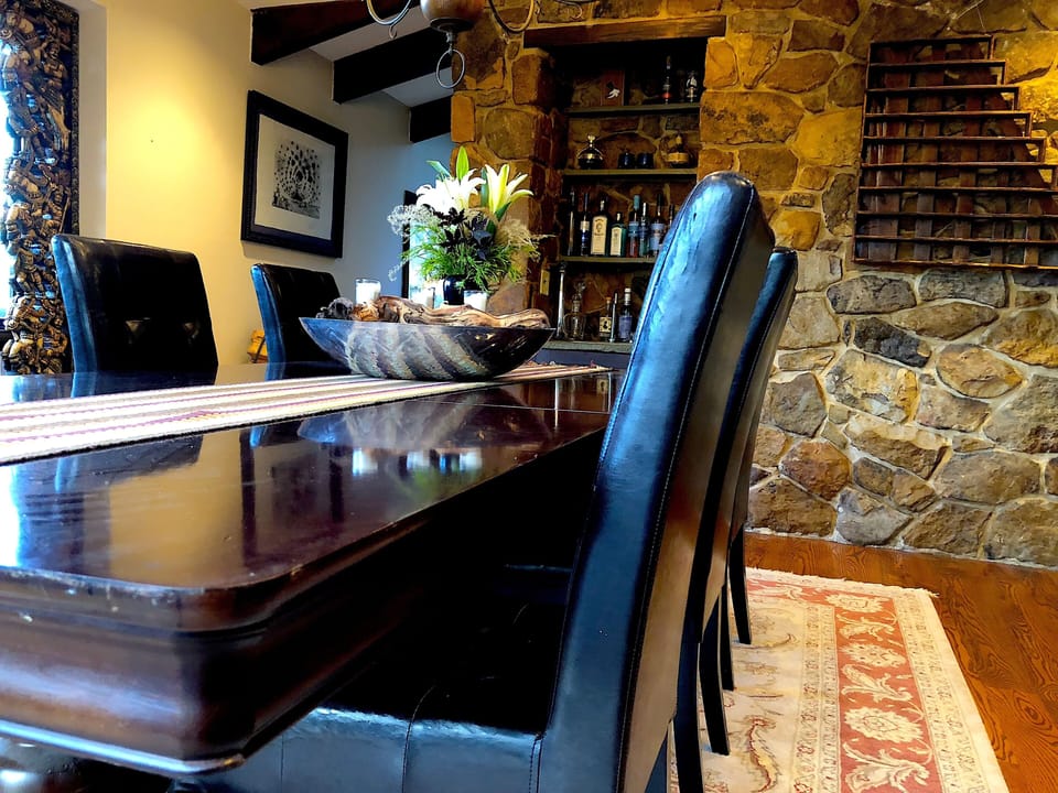 The dining table can seat up to 12 guests, with more seating in the kitchen