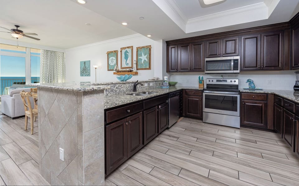 Prepare meals in this kitchen with elegant cabinetry, stainless appliances, and spacious countertops