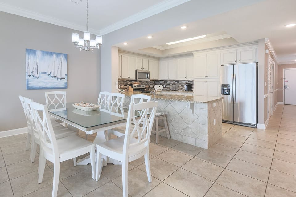 Gather around the stylish dining table, where laughter and conversation flow effortlessly in this inviting space