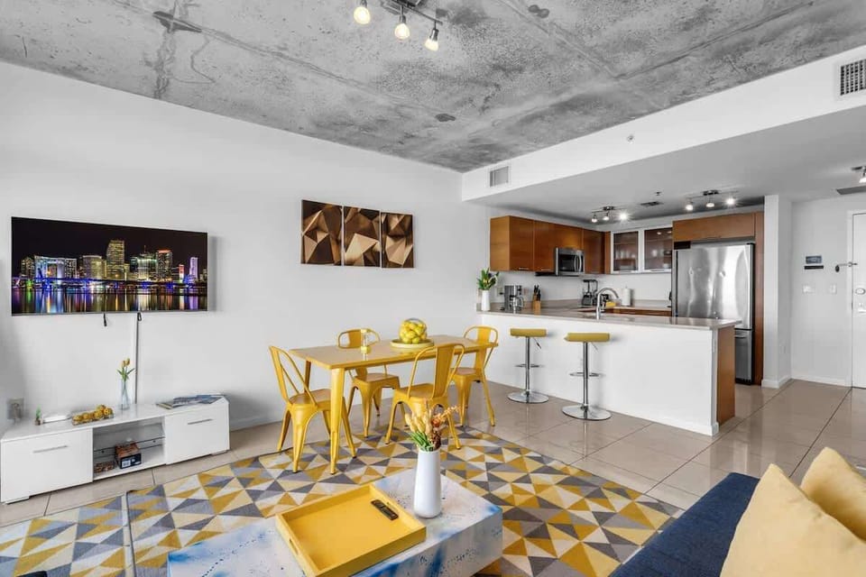 "Enjoy open living in this Airbnb apartment with modern kitchen, stylish dining, and vibrant décor."

