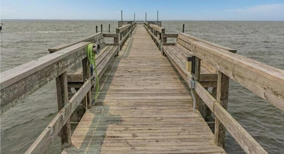 The Ships Watch Community Sound Pier extends over calm waters, offering a peaceful spot to fish, stroll, or simply enjoy the surrounding natural waterfront and coastal views.