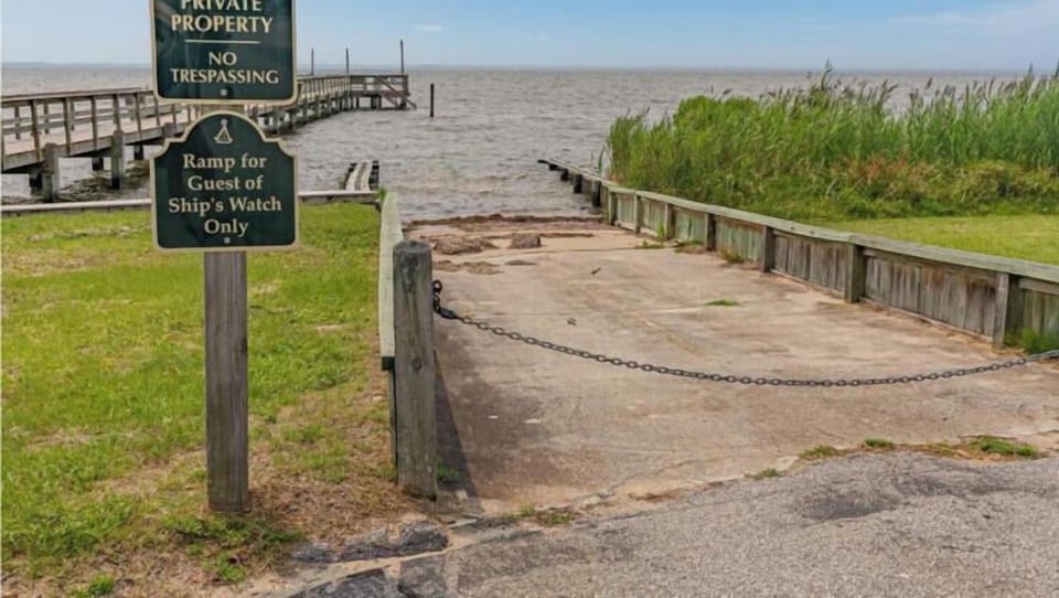 Ships Watch Community Boat Ramp offers waterfront access to the expansive bay, with wooden docks, a private launch area, and scenic water views surrounded by coastal marshland.