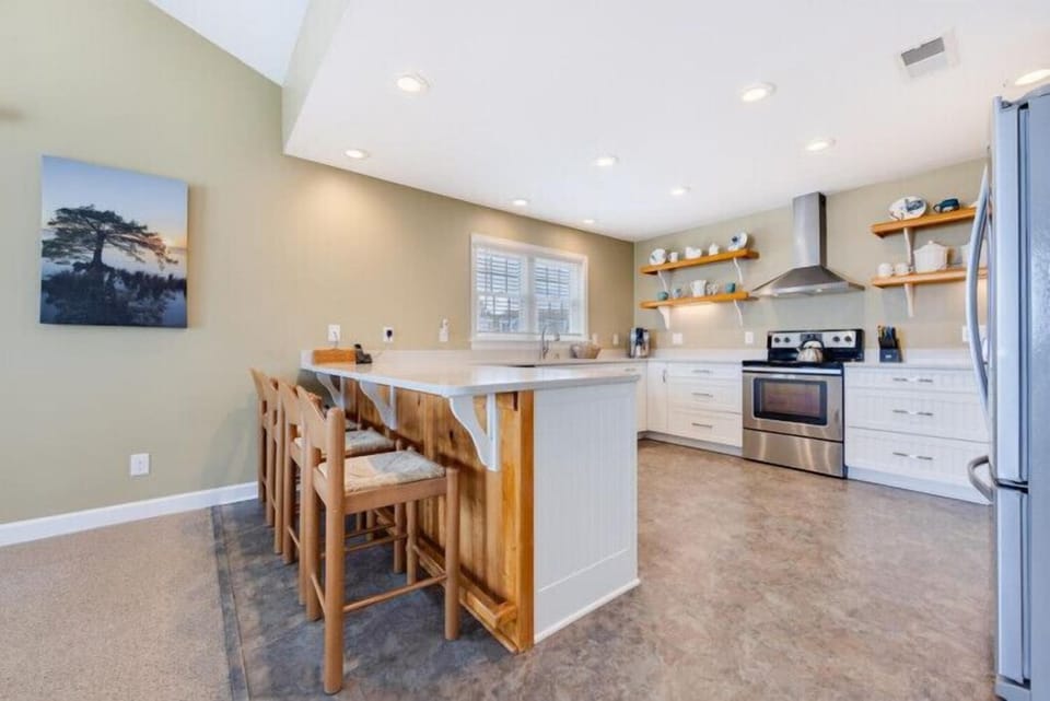 You'll love preparing meals in this bright, open kitchen with a large island, modern appliances, and warm wood accents that make it feel like home.