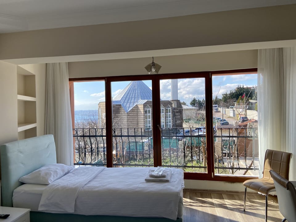 Room 5 - Triple Room With Sea View | Desk, laptop workspace, soundproofing, iron/ironing board