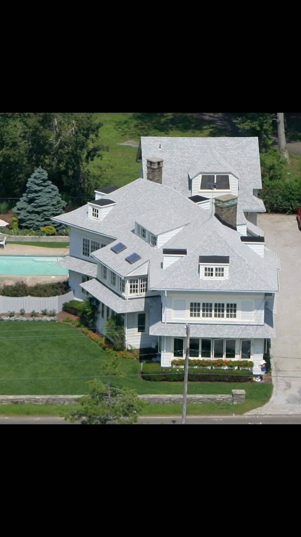 Drone view, showing home, driveway and pool.