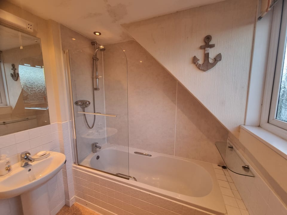 Large bathroom with bath, shower, toilet and sink