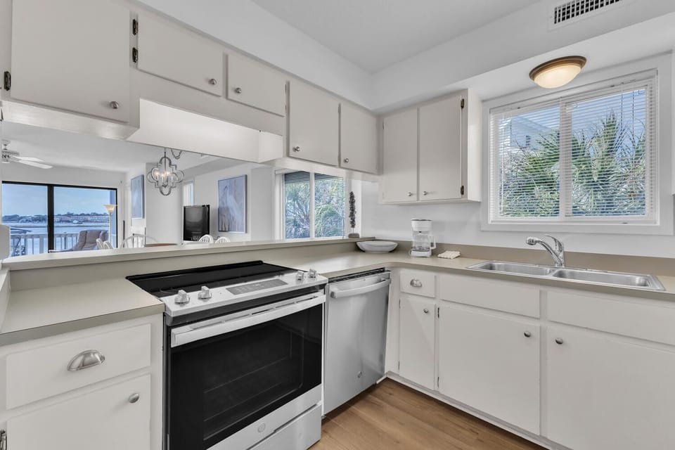 Cook with ease in your bright, fully-equipped kitchen featuring modern appliances and ample counter space for vacation meal prep.
