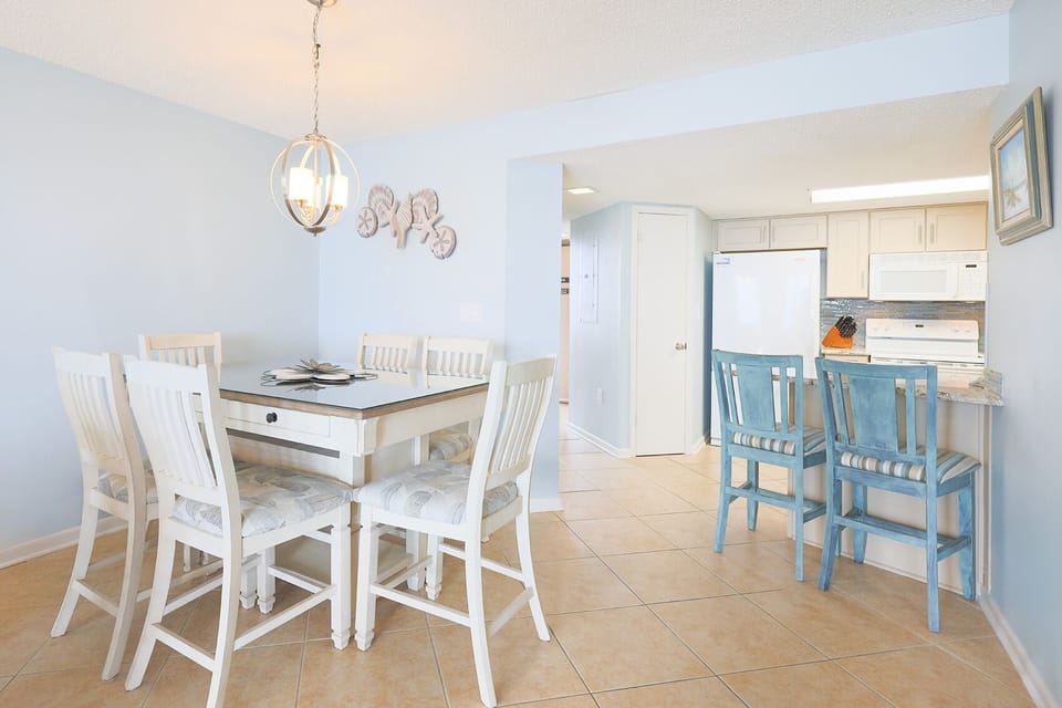 Gather around the dining table or enjoy a quick bite at the breakfast bar in this welcoming dining area