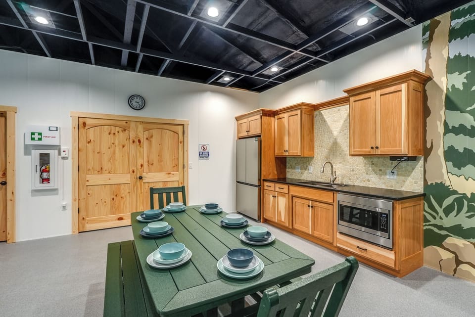 Kitchenette with fridge, sink, and microwave