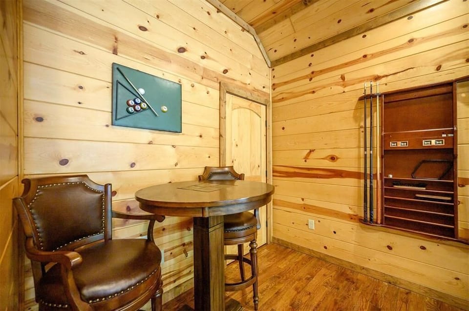 Step into your private game nook, where rustic charm meets friendly competition. Grab a cue, sink into rich leather seating, and enjoy downtime in this cozy wood-paneled retreat.