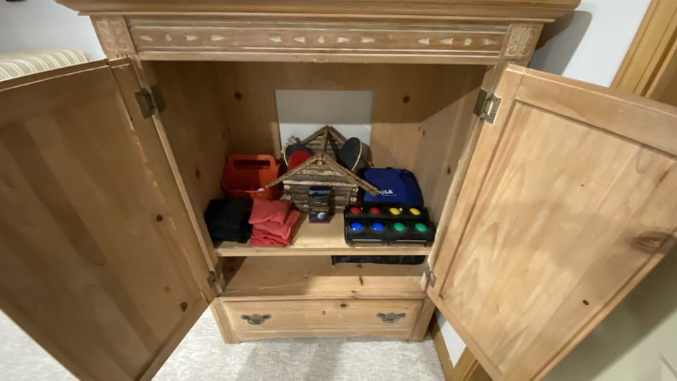The downstairs cabinet holds many games.
