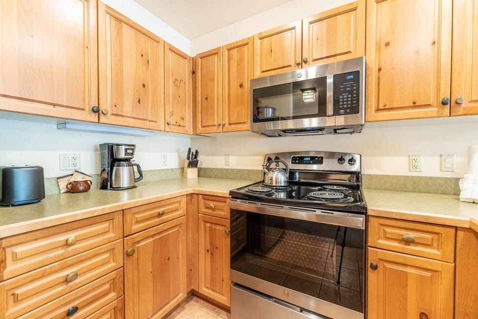 Full size kitchen with stainless steel appliances.