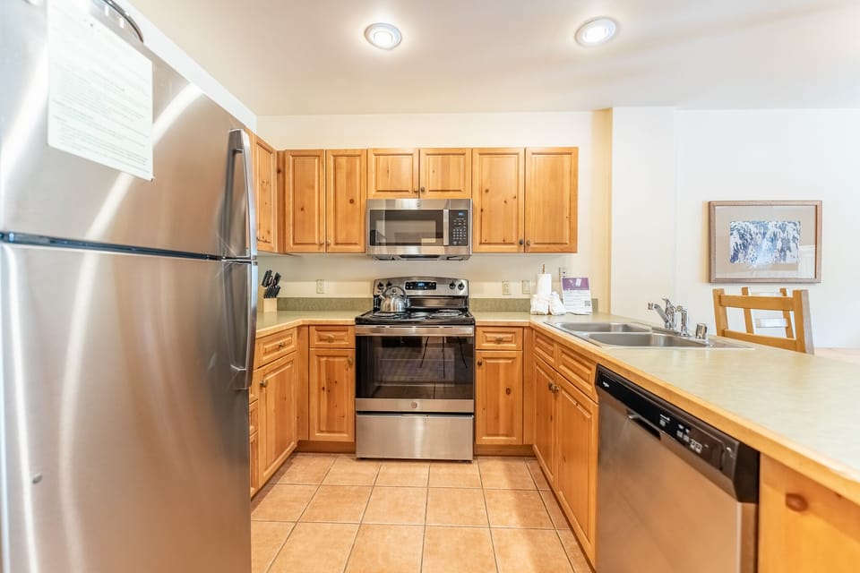 Full size kitchen with stainless steel appliances.