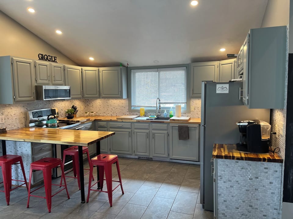 upper floor open concept living room with kitchen and dining area