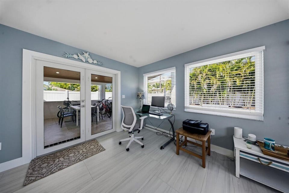 Office area leading out to lanai, overlooking pool