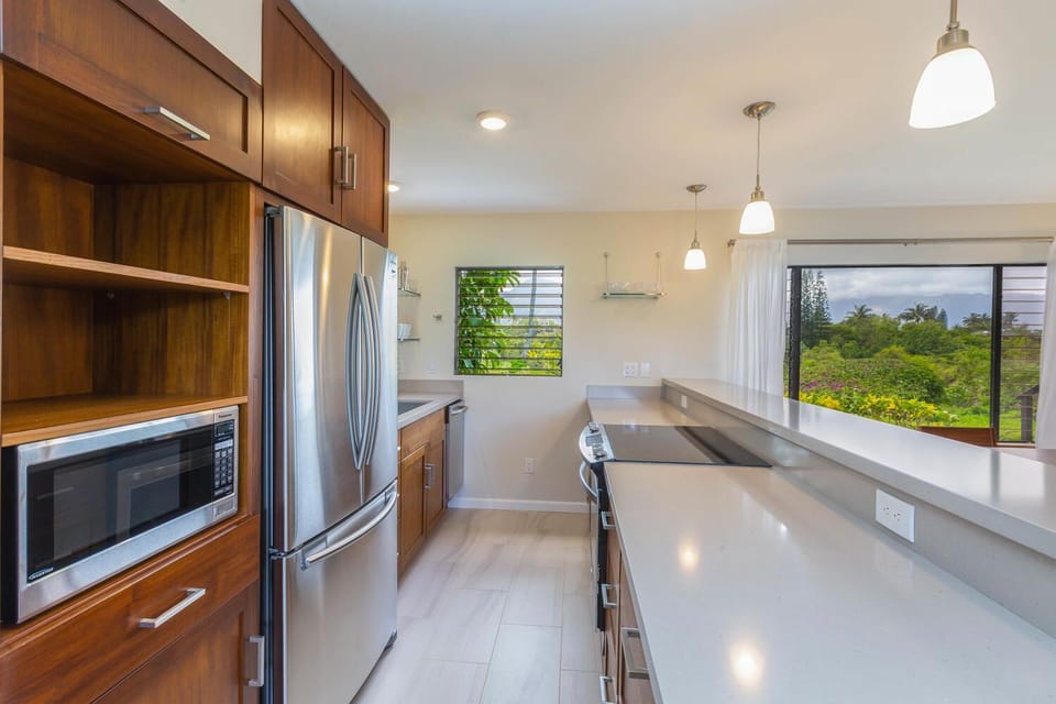 Teak cabinetry completes this sleek kitchen